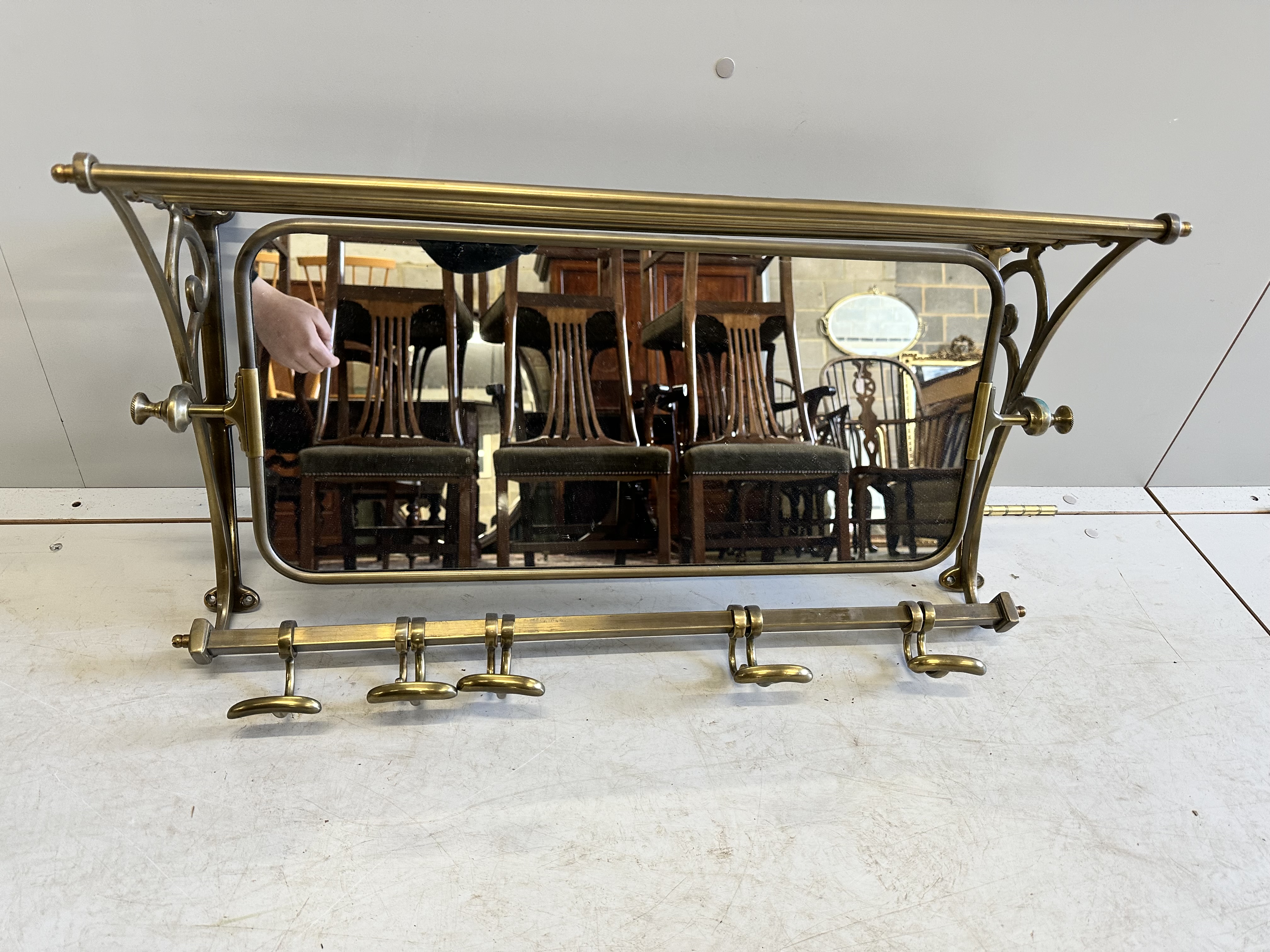 A French mirrored brass hanging coat stand, width 75cm, depth 23cm, height 38cm